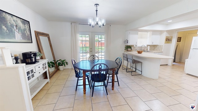 9 Camelia Ln, Texarkana, TX 75503 - dining space with a chandelier, light tile patterned flooring, ornamental molding, and french doors