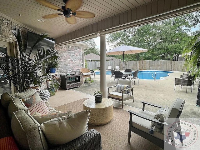 view of patio featuring outdoor lounge area, a fenced backyard, a fenced in pool, and a ceiling fan