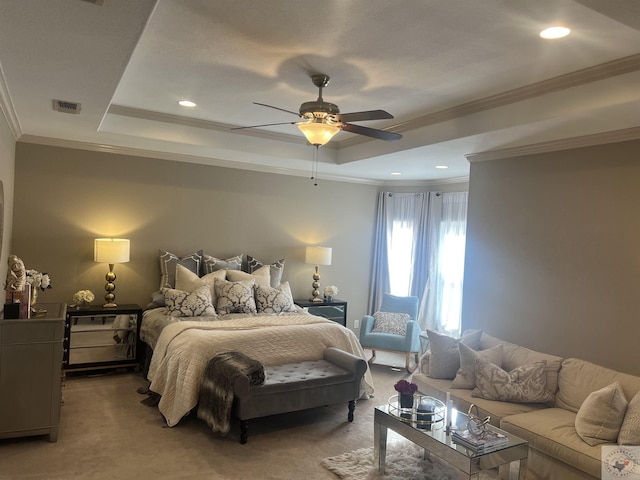 carpeted bedroom with a raised ceiling, visible vents, and crown molding