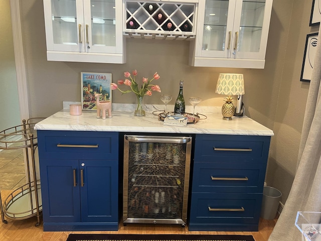 bar featuring wine cooler and a dry bar