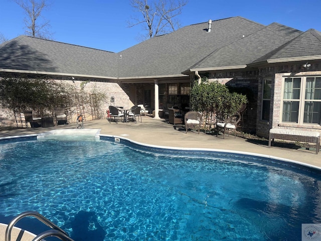 outdoor pool with a patio area