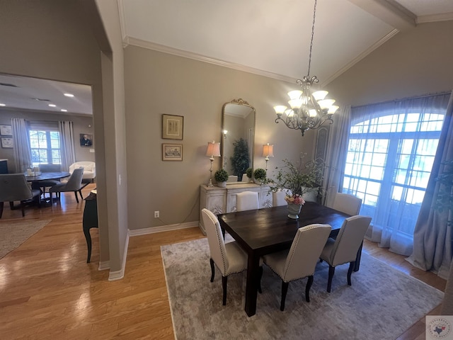 dining space featuring lofted ceiling with beams, a notable chandelier, baseboards, light wood-style floors, and crown molding