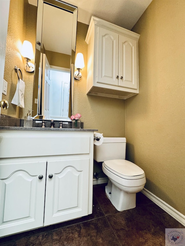 bathroom featuring vanity, toilet, and tile patterned floors