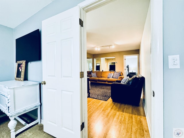 interior space with track lighting and hardwood / wood-style floors