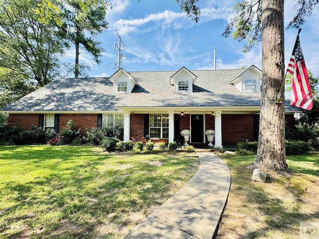 new england style home featuring a front yard