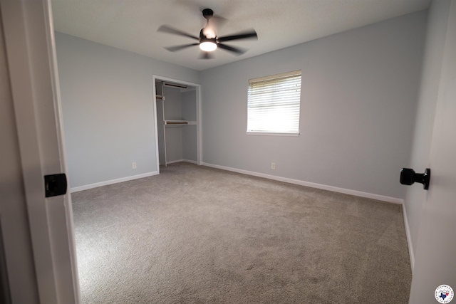 unfurnished bedroom featuring carpet floors, baseboards, a ceiling fan, and a closet