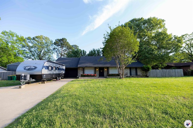 view of front of property with driveway, a garage, fence, and a front lawn
