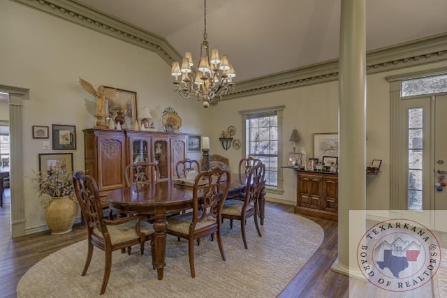 dining space with crown molding, a chandelier, vaulted ceiling, and dark hardwood / wood-style flooring