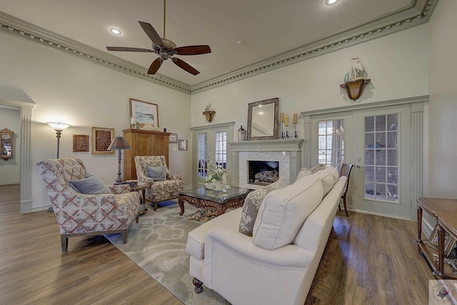 living room with crown molding, hardwood / wood-style flooring, ceiling fan, and french doors