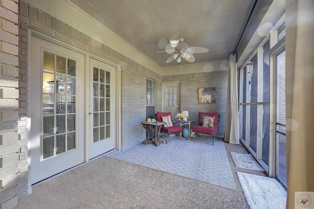 sunroom / solarium featuring ceiling fan and french doors