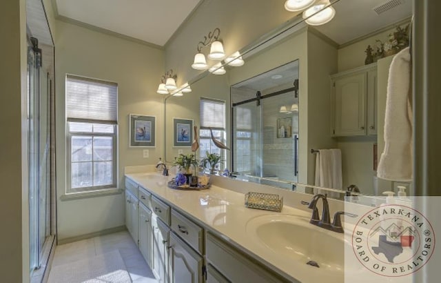 bathroom with vanity, crown molding, and an enclosed shower