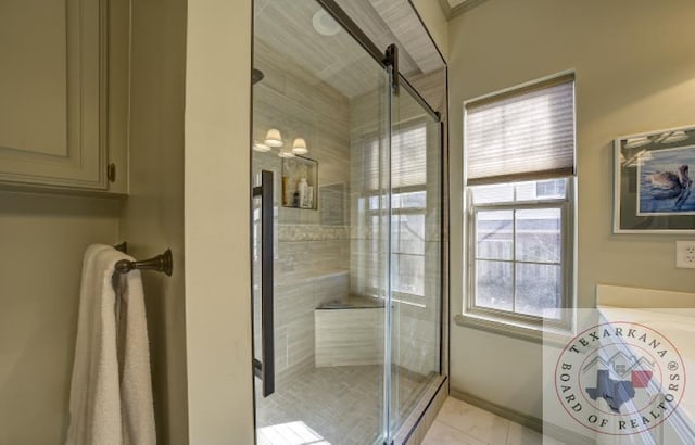 bathroom with a shower with shower door and tile patterned floors