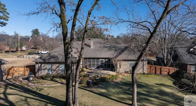 exterior space featuring a yard and a sunroom