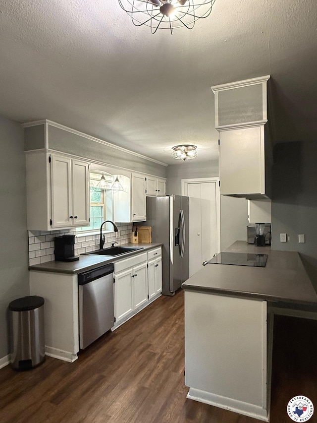 202 Mehaffey Dr, Dekalb, TX 75559 - kitchen featuring stainless steel appliances, a sink, backsplash, white cabinets, and dark wood finished floors