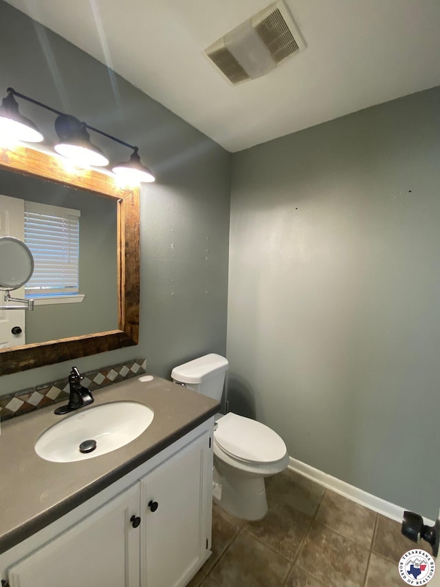 202 Mehaffey Dr, Dekalb, TX 75559 - half bathroom with toilet, vanity, tile patterned flooring, and baseboards