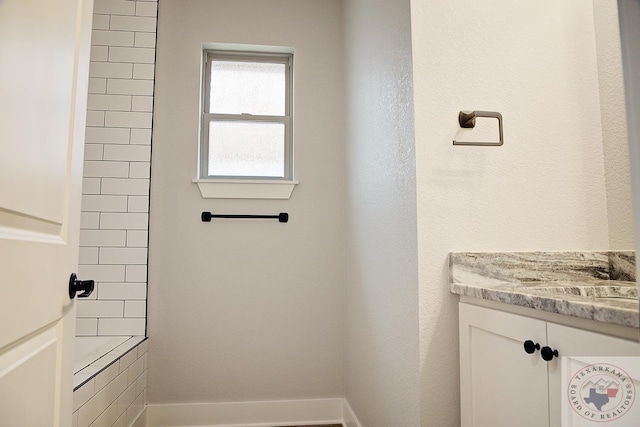 bathroom featuring vanity and a shower