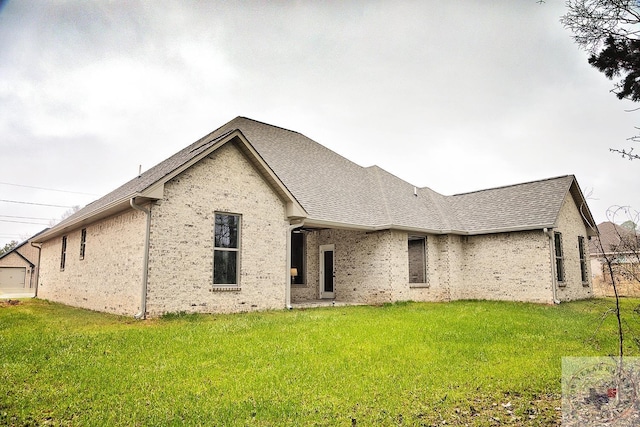 rear view of property featuring a yard