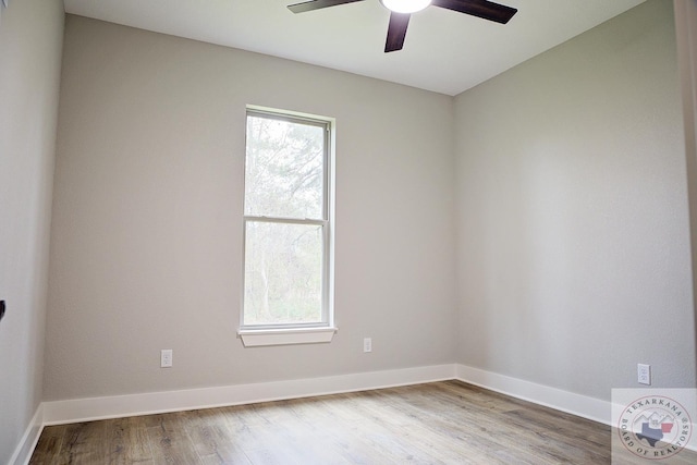 unfurnished room with wood-type flooring, a wealth of natural light, and ceiling fan