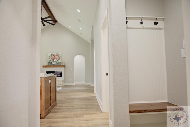 mudroom with vaulted ceiling with beams, light hardwood / wood-style flooring, and ceiling fan