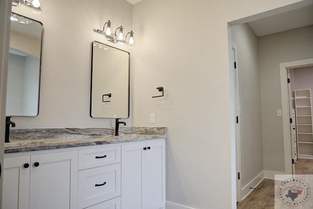 bathroom featuring vanity and wood-type flooring