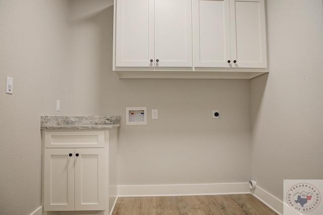 clothes washing area with hookup for a washing machine, light wood-type flooring, hookup for an electric dryer, and cabinets