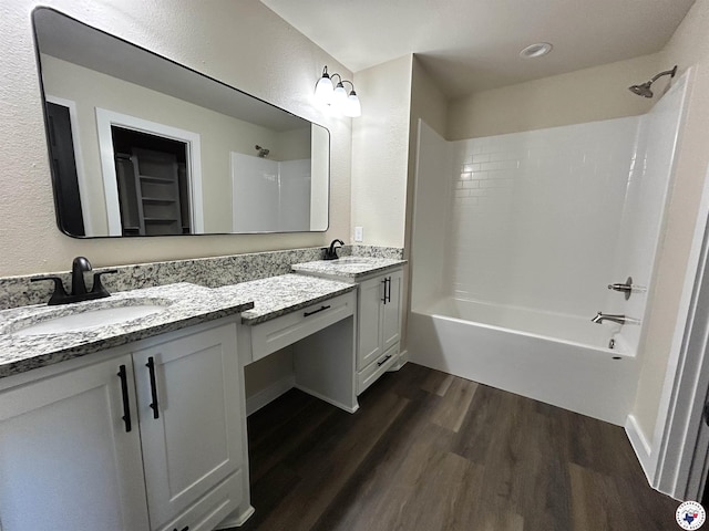 110 Village Pl, Wake Village, TX 75501 - bathroom with double vanity, shower / bathtub combination, a sink, and wood finished floors