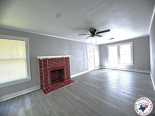 unfurnished living room with baseboards, ceiling fan, ornamental molding, and wood finished floors