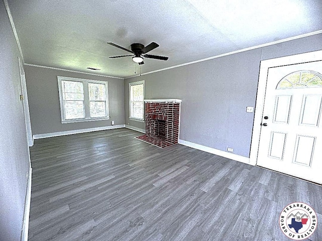 unfurnished living room with dark wood-style flooring, ornamental molding, a textured ceiling, and ceiling fan