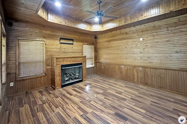 7 Coppercreek Cir, Texarkana, TX 75503 - unfurnished living room with a ceiling fan, wooden walls, a fireplace, and wood finished floors