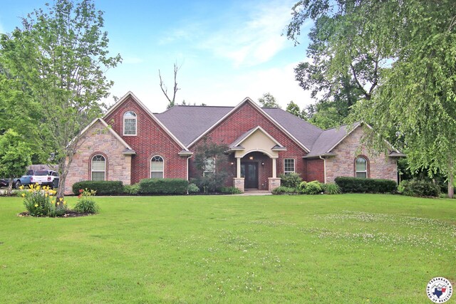 7 Coppercreek Cir, Texarkana, TX 75503 - view of front facade with a front yard, stone siding, and brick siding
