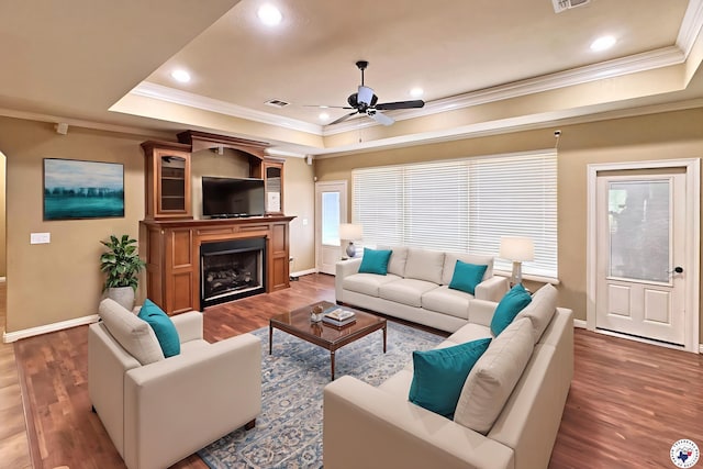 7 Coppercreek Cir, Texarkana, TX 75503 - living room with a raised ceiling, crown molding, a ceiling fan, wood finished floors, and baseboards