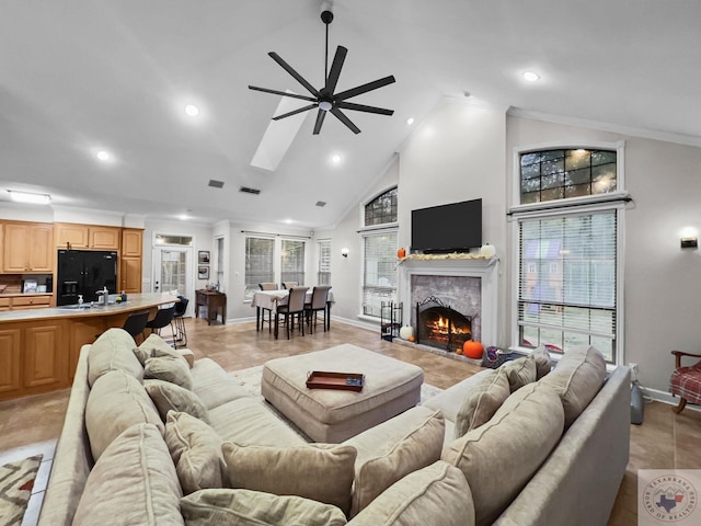 living room with ceiling fan, high vaulted ceiling, and ornamental molding