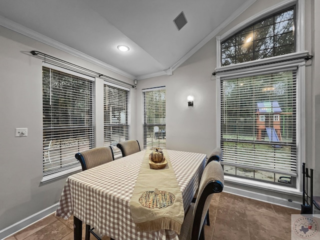 dining room with ornamental molding and lofted ceiling