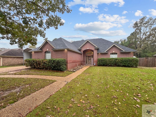 ranch-style home with a front yard