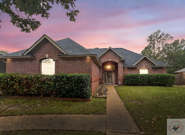 view of front of property with a lawn