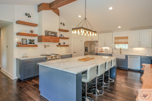 kitchen featuring open shelves, a sink, vaulted ceiling with beams, stainless steel appliances, and dark wood-style floors