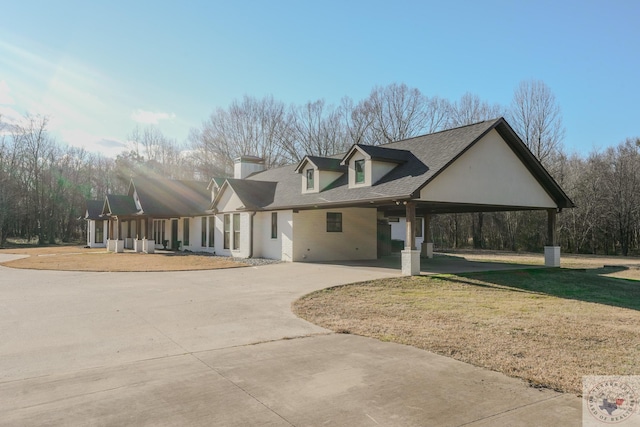 view of front of house featuring a carport and a front lawn