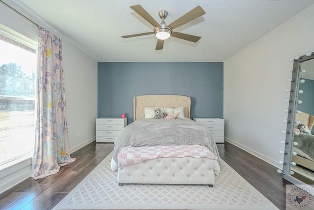bedroom with wood finished floors, a ceiling fan, and baseboards
