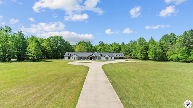 view of front facade with a front lawn and concrete driveway