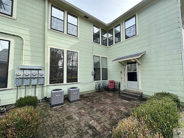 back of property featuring central AC and a patio