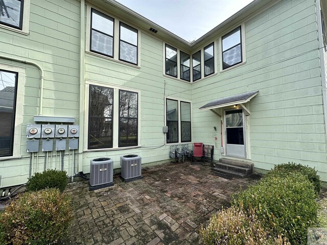 back of property featuring central AC and a patio