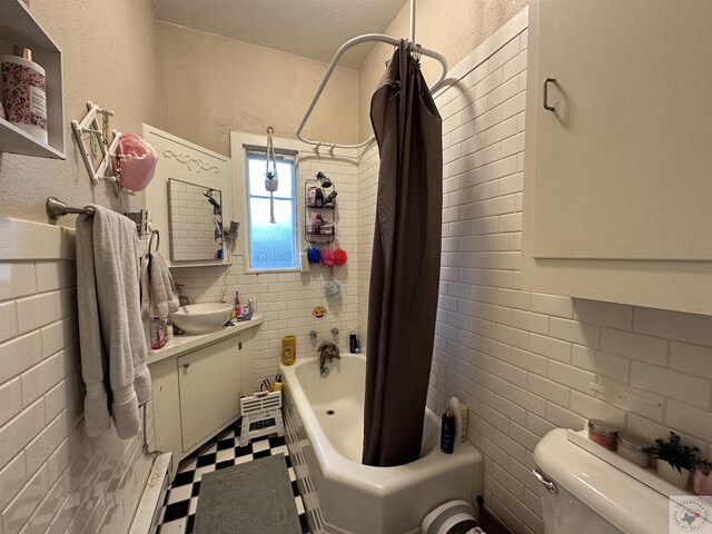 full bathroom with shower / bath combo with shower curtain, toilet, and vanity