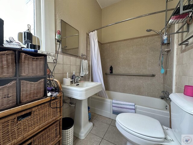 bathroom featuring tile walls, toilet, shower / tub combo, and tile patterned flooring