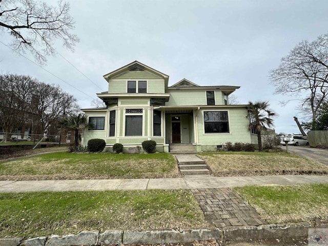 bungalow-style home with a front yard