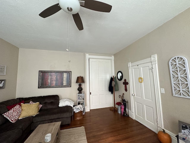 living room with dark wood-type flooring and a textured ceiling