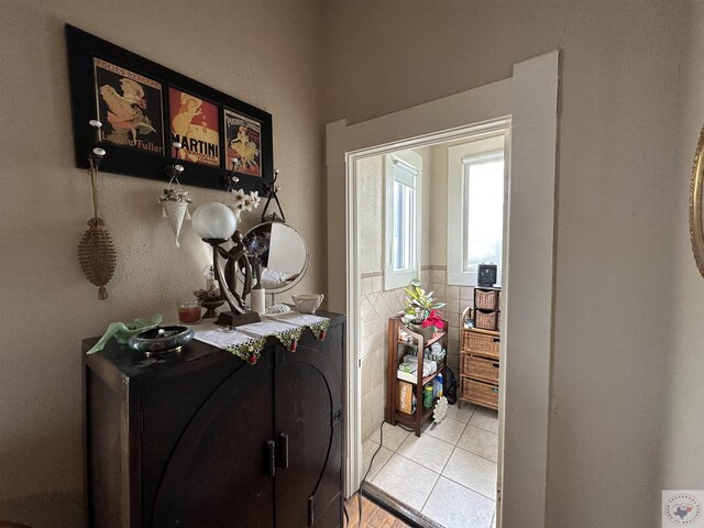 doorway to outside with light tile patterned floors