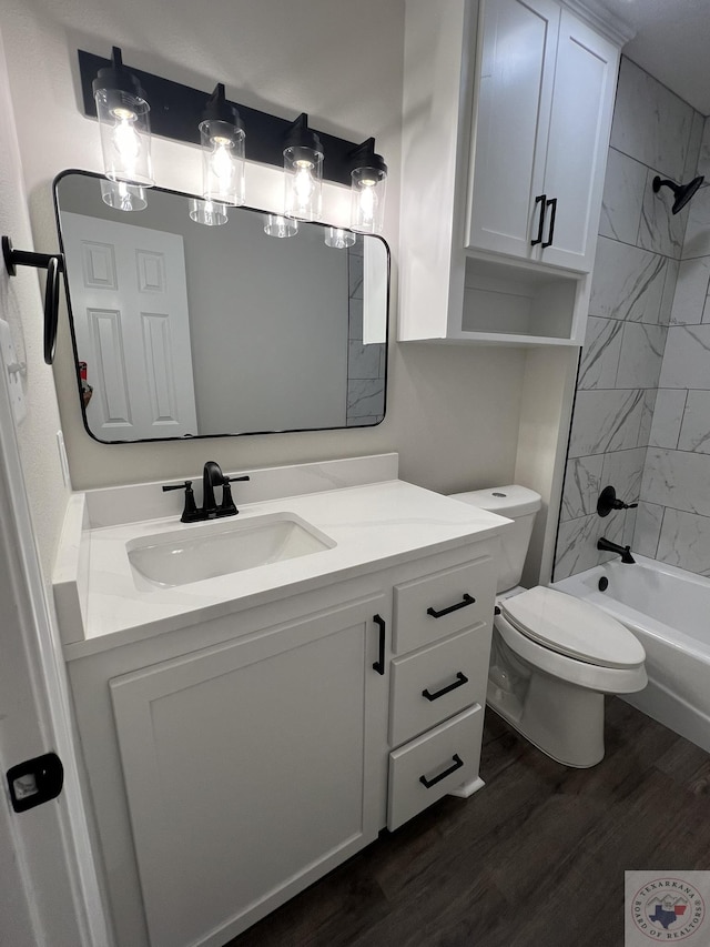 bathroom featuring toilet, vanity, shower / bathtub combination, and wood finished floors