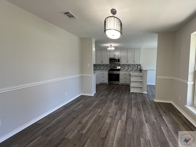 kitchen featuring visible vents, a sink, backsplash, appliances with stainless steel finishes, and light countertops