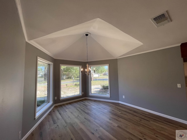 unfurnished dining area featuring a wealth of natural light, hardwood / wood-style floors, lofted ceiling, an inviting chandelier, and ornamental molding