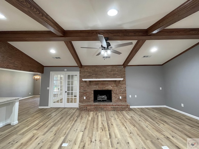 unfurnished living room with a fireplace, light wood-type flooring, french doors, beam ceiling, and ceiling fan